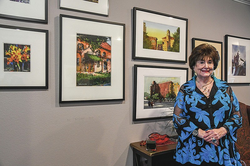 Dorothy Morris is photographed on April 24, 2020, standing by paintings in her home all done by local artists.-Photo by Grace Brown of The Sentinel-Record
