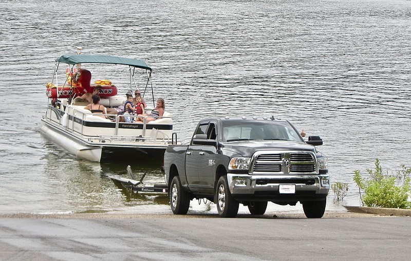 Family members take their boat ashore at DeGray Lake Resort State Park.

(Special to the Democrat-Gazette/Marcia Schnedler)