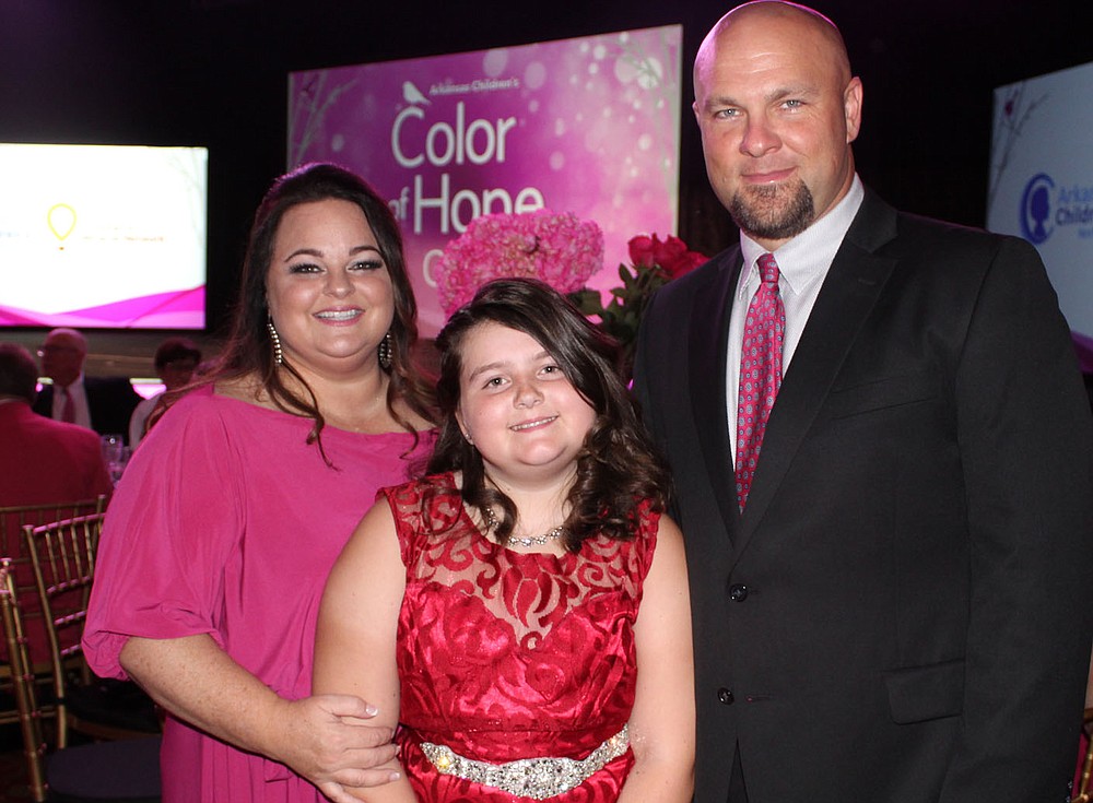 NWA Democrat-Gazette/CARIN SCHOPPMEYER Color of Hope Champion Child Addison Alford (center) and Robby and Corey Fund enjoy the Arkansas Children's Northwest fundraiser.