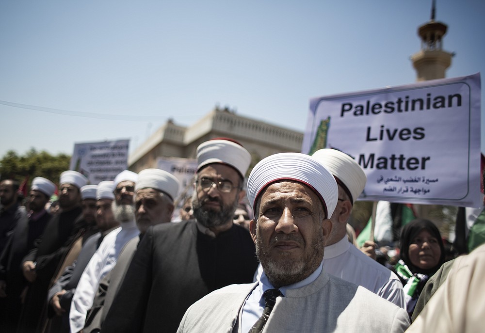 Palestinian Muslim clerics attend a demonstration against Israeli plans for the annexation of parts of the West Bank, in Gaza City, Wednesday, July 1, 2020. (AP Photo/Khalil Hamra)