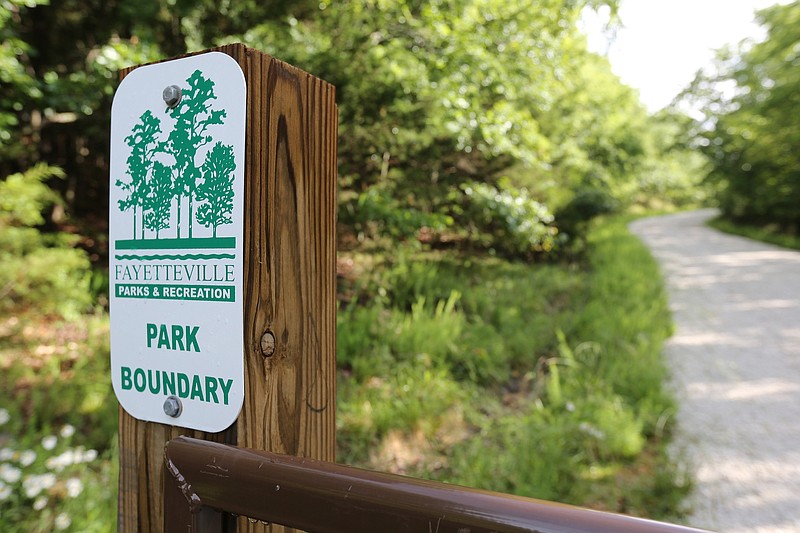 NWA Democrat-Gazette/DAVID GOTTSCHALK A city of Fayetteville Parks and Recreation boundary gate is visible Thursday, June 6, 2019, at the end of Centennial Park Lane on the southwest side of Millsap Mountain in Fayetteville. The City Council on Tuesday approved the conceptual master plan to build Centennial Park at Millsap Mountain, which will be a mountain-biking and cyclocross attraction. The project also is set to receive $985,000 in voter-approved bond money.