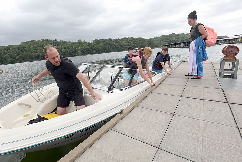 David Verkest of Centerton (left) and his crew pick up passengers including Joleen Verkest (right) on Wedenesday July 1 2020 for family outing on Beaver Lake. Independence Day weekend is one of the busiest of the year at the lake. Go to nwaonline.com/200702Daily/ to see more photos.
(NWA Democrat-Gazette/Flip Putthoff)