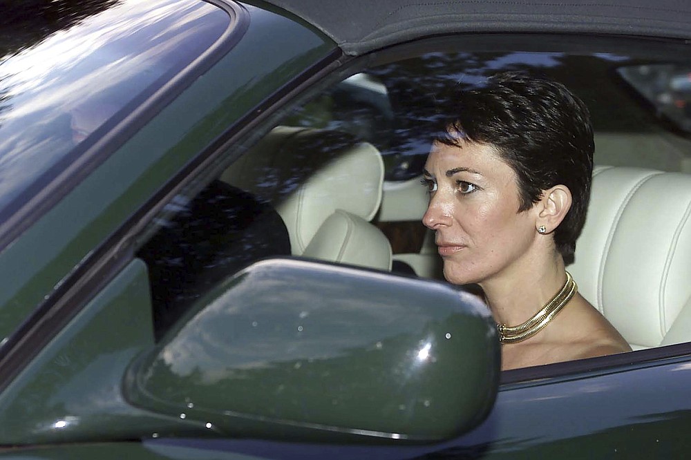 FILE - In this Sept. 2, 2000 file photo, British socialite Ghislaine Maxwell, driven by Britain's Prince Andrew leaves the wedding of a former girlfriend of the prince, Aurelia Cecil, at the Parish Church of St Michael in Compton Chamberlayne near Salisbury, England. The FBI said Thursday July 2, 2020, Ghislaine Maxwell, who was accused by many women of helping procure underage sex partners for Jeffrey Epstein, has been arrested in New Hampshire. (Chris Ison/PA via AP, File)
