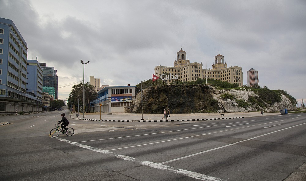 Hotel Nacional stands tall near the empty intersection of 23rd Street and the Malecon seawall, amid a lockdown to curb the spread of COVID-19 in Havana, Cuba, Saturday, June 20, 2020. Like other Caribbean islands, Cuba is highly dependent on tourism. It also earns hard currency from the export of medical and other professional services, remittances, and subsidized petroleum from Venezuela. (AP Photo/Ismael Francisco)