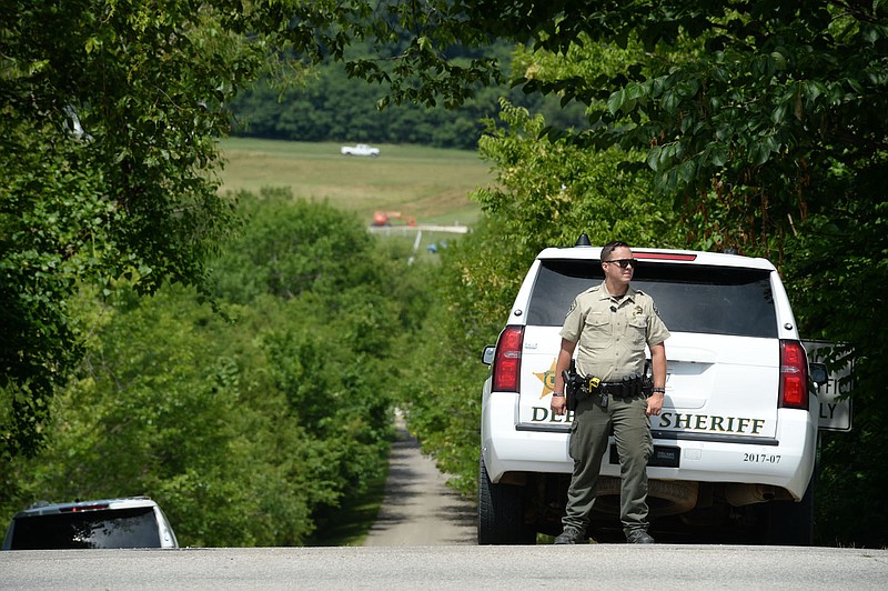 A Washington County Sheriff’s Office deputy stands Friday at Sunrise Mountain Road and School Avenue in Fayetteville. According to the Fayetteville Police Department, a shooting and hostage situation was reported at an address on Sunrise Mountain Road. Go to nwaonline.com/200704Daily/ for today’s photo gallery.
(NWA Democrat-Gazette/Andy Shupe)