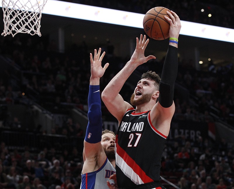 Portland Trail Blazers center Jusuf Nurkic, right, shoots as Detroit Pistons forward Blake Griffin defends during the second half of a March 23, 2019, basketball game in Portland, Ore. Jusuf Nurkic is back and healthy. So are Zach Collins, Meyers Leonard, Giannis Antetokounmpo, Anthony Davis and plenty of others. If the four-month NBA shutdown had a silver lining, it’s that a lot of ailing players got well. - Photo by Steve Dipaola of The Associated Press