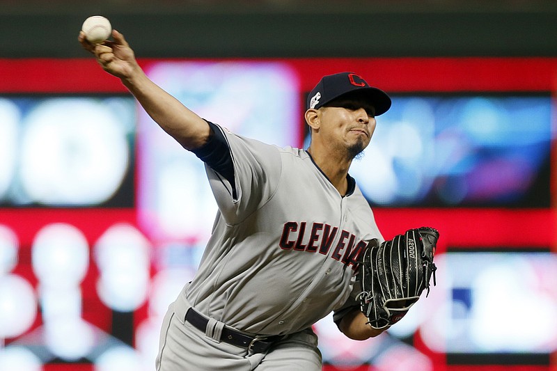 FILE - In this Sept 6, 2019, file photo, Cleveland Indians pitcher Carlos Carrasco throws against the Minnesota Twins in a baseball game in Minneapolis. The Indians’ right-hander, who made a dramatic comeback last season after being diagnosed with leukemia, has been cleared to pitch and is thrilled to be back on the field after baseball was shut down during the COVID-19 pandemic. Carrasco said his health is good and his doctors have approved him playing despite the inherent risks. (AP Photo/Jim Mone, File)