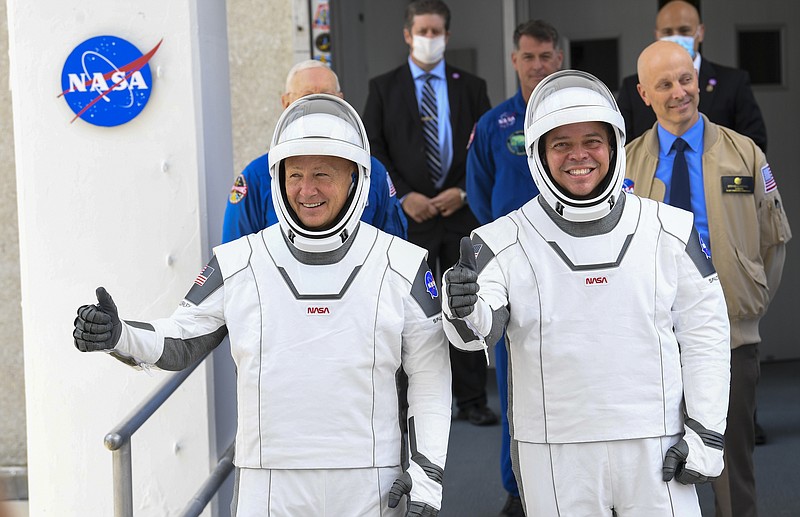 NASA commercial crew astronauts Doug Hurley, left, and Bob Behnken leave for their flight aboard the SpaceX Falcon 9 rocket on May 27, 2020. MUST CREDIT: Washington Post photo by Jonathan Newton