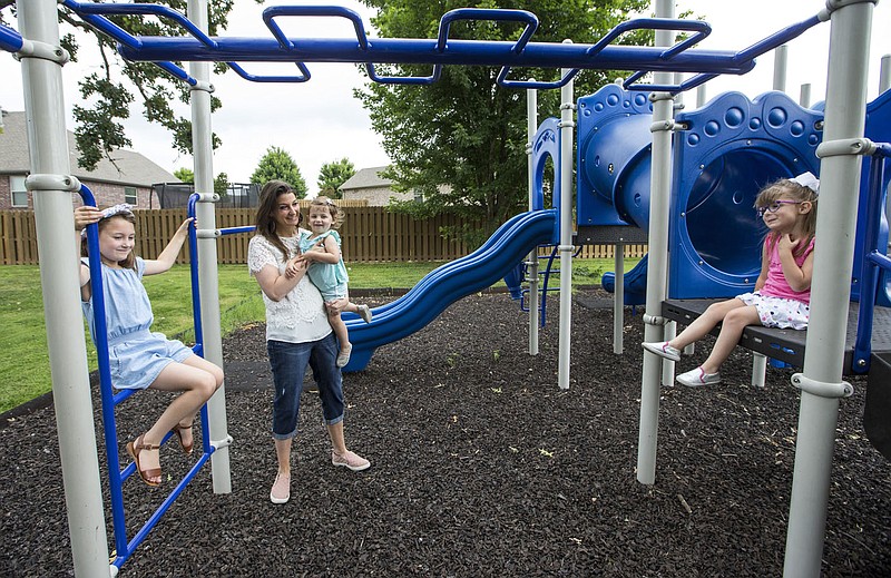 Whitney Killebrew plays Friday, June 26, 2020, with her daughters Audrey Killebrew (from left), 7, Joelle Killebrew, 1, and Sloane Killebrew, 4, and at the park in their Bentonville neighborhood. Go to nwaonline.com/200627Daily/ to see more photos.
(NWA Democrat-Gazette/Ben Goff)