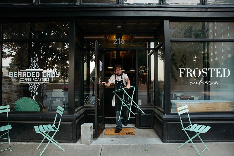 At Frosted Cakerie on Main Street in Joplin, Mo., an employee sets up outdoor seating for the day on July 2, 2020. MUST CREDIT: Photo for The Washington Post by Terra Fondriest