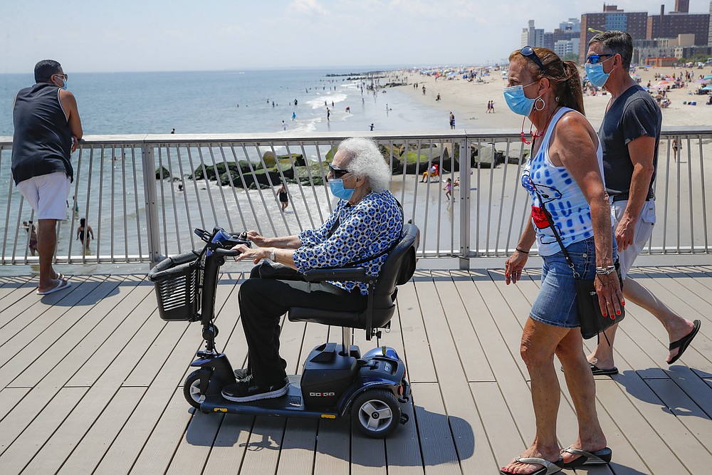 Revelers enjoy the beach at Coney Island, Saturday, July 4, 2020, in the Brooklyn borough of New York. (AP Photo/John Minchillo)