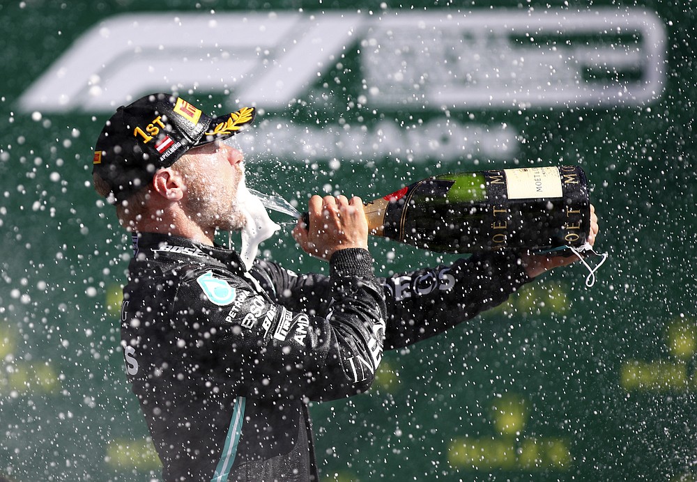 Mercedes driver Valtteri Bottas of Finland sprays champagne after winning the Austrian Formula One Grand Prix at the Red Bull Ring racetrack in Spielberg, Austria, Sunday, July 5, 2020. (Mark Thompson/Pool via AP)