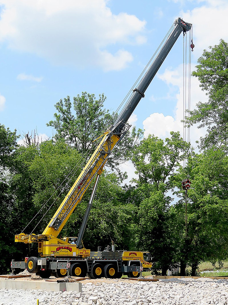 Westside Eagle Observer/RANDY MOLL
A large crane was in place on the north side of Flint Creek on Monday in readiness to place bridge supports.