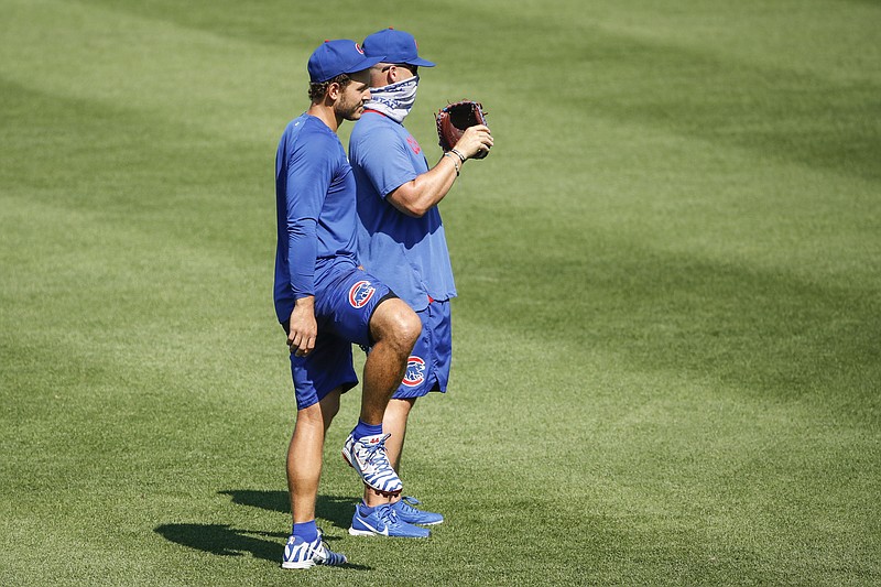 Chicago Cubs first baseman Anthony Rizzo, left, stands next to manager David Ross, right, during baseball practice at Wrigley Field, Sunday, July 5, 2020, in Chicago. (AP Photo/Kamil Krzaczynski)