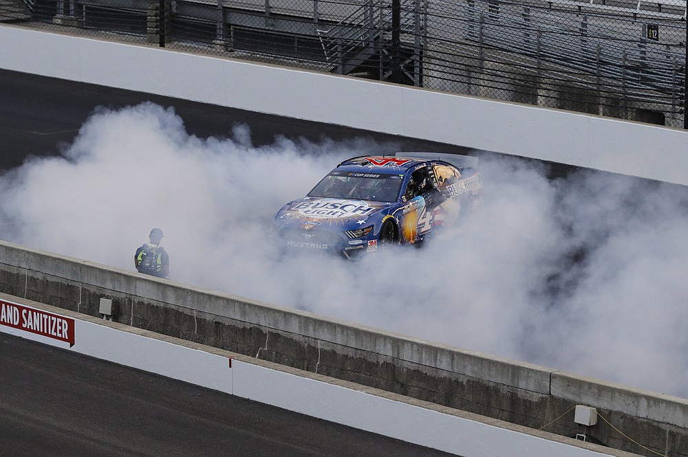 Kevin Harvick does a burnout after winning the NASCAR Cup Series auto race at Indianapolis Motor Speedway in Indianapolis, Sunday, July 5, 2020. (AP Photo/Darron Cummings)