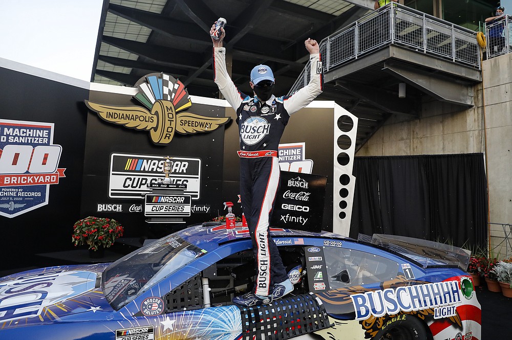 Race driver Kevin Harvick celebrates after winning the NASCAR Cup Series auto race at Indianapolis Motor Speedway in Indianapolis, Sunday, July 5, 2020. (AP Photo/Darron Cummings)