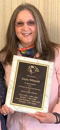 SUBMITTED
Gayla Wilmoth holds a plaque she was presented upon her retirement in appreciation for her 34 years of service in the Gentry School District.