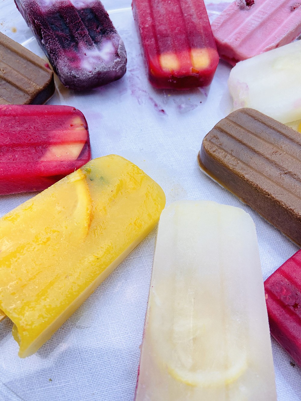 Chocolate, blueberry with greek yogurt, peach raspberry, lemon-lime, mango orange and strawberry-raspberry ice pops. (The Philadelphia Inquirer/TNS/Jamila Robinson)