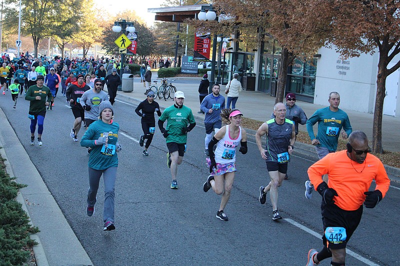 Runners start the Spa Running Festival's 5K in November 2019 in front of the Hot Springs Convention Center. - File photo by The Sentinel-Record