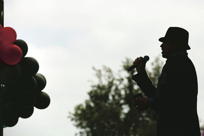 FILE - In the June 19, 2020 file photo, Imani Abdul sings "Lift Every Voice and Sing" during a Juneteenth celebration in Los Angeles. The Black national anthem was born more than a century ago, but the popular hymn within the African American community called "Lift Every Voice and Sing" has been resurrected as a beacon of hope for all races during nationwide protests. (AP Photo/Jae C. Hong, File)