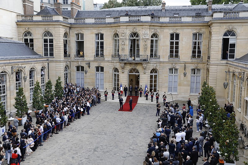 Newly named Prime Minister Jean Castex, center right, and outgoing French Prime Minister Edouard Philippe speak after the handover ceremony in Paris, Friday, July 3, 2020. French President Emmanuel Macron on Friday named Jean Castex, who coordinated France's virus reopening strategy, as the country's new prime minister as the country focuses on reviving an economy hard-hit by the pandemic and months of strict lockdown. (Thomas Samson, Pool via AP)