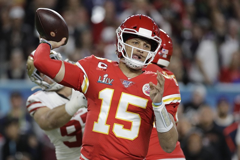 FILE - In this Feb. 2, 2020, file photo, Kansas City Chiefs quarterback Patrick Mahomes (15) passes against the San Francisco 49ers during the first half of the NFL Super Bowl 54 football game in Miami Gardens, Fla. The Chiefs have agreed to a 10-year contract extension with Super Bowl MVP Mahomes keeping him around through 2031. The Chiefs had Mahomes under contract for the next two seasons but wanted a long-term deal in place with the quarterback who led them to their first championship in 50 years.  ESPN.com reported the deal is worth $450 million with an injury guarantee of $140 million. (AP Photo/Patrick Semansky, File)