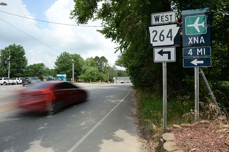 Traffic  passes Thursday, July 2, 2020, along Main Street in Cave Springs near the turnoff to Healing Springs Road (Arkansas 264) and the Northwest Arkansas National Airport in Highfill. Arkansas highway officials are considering a new road to connect the Bella Vista Bypass and the Springdale Northern Bypass via the Northwest Arkansas National Airport. The Arkansas Department of Transportation is hosting a virtual public input session that runs through July 13 to gather input from residents. Visit nwaonline.com/200705Daily/ for today's photo gallery.
(NWA Democrat-Gazette/Andy Shupe)