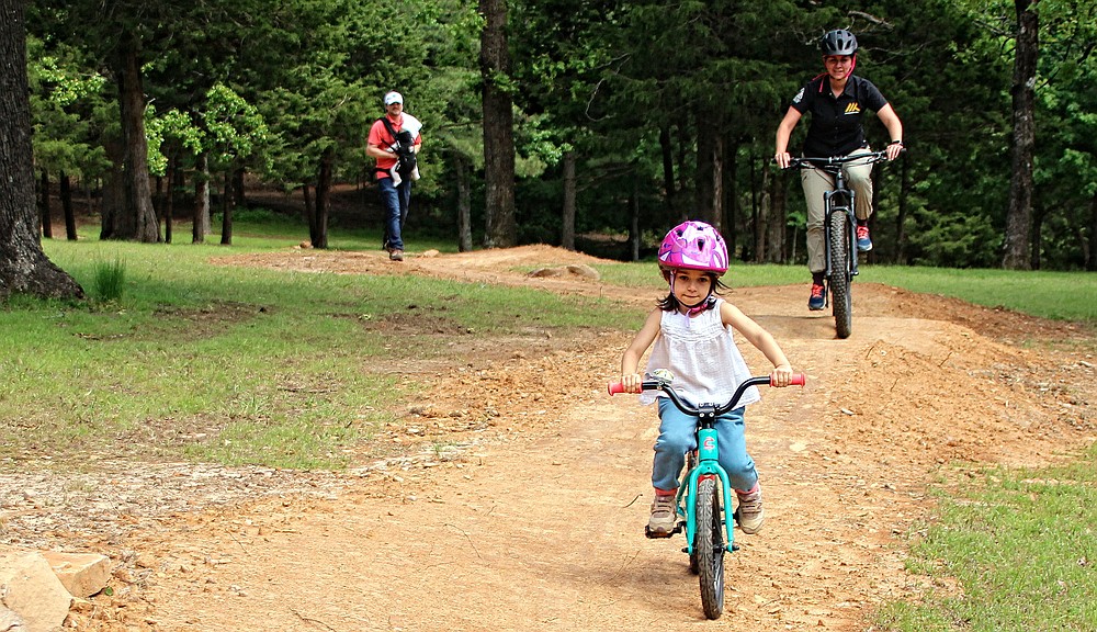 Suzanne Grobmeyer, executive director for the Arkansas Parks and Recreation Foundation, pursues her daughter Margaret with husband Andrew and son George following on a child-friendly path at Mount Nebo State Park. (Special to the Democrat-Gazette/Bob Robinson)