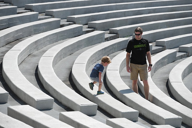 Collin Selman of Clinton MS and his son Samuel Selman, 3, explore the Chi Omega Greek Theater on the University of Arkansas campus in Fayetteville Tuesday. Selman is a graduate of the UA. The Greek Theater was a gift to the university from Chi Omega, and it was completed in 1930. It was added to the National Register of Historic Places in 1992. Visit nwaonline.com/200707Daily/ for photo galleries. (NWA Democrat-Gazette/J.T. Wampler)