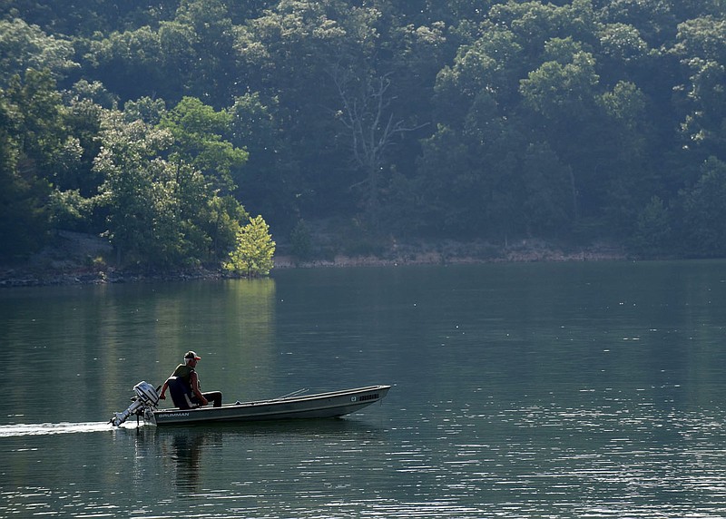 MORNING CRUISE
A boater idles along Beaver Lake early Tuesday July 7 2020 near Prairie Creek park. Anglers make up the majority of early-bird boaters during summer at the reservoir. Go to nwaonline.com/200708Daily/ to see more photos.
(NWA Democrat-Gazette/Flip Putthoff) story.lead_photo.caption