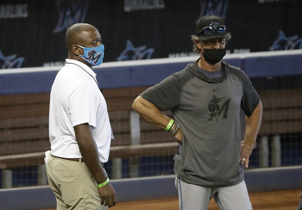 Miami Marlins president of baseball operations Michael Hill, left, talks with manager Don Mattingly during a baseball workout at Marlins Park, Sunday, July 5, 2020, in Miami. (AP Photo/Wilfredo Lee)