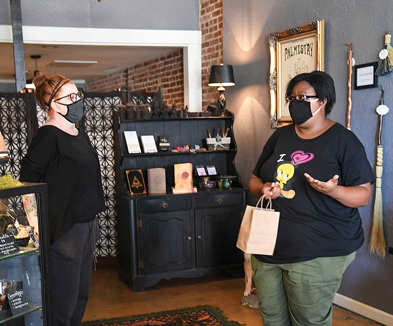 Breyona Canady, right, speaks to shop owner Amy Davis after making a purchase at The Parlor Hot Springs, 340 Ouachita Ave., on Wednesday. The Parlor will be selling face masks starting on Saturday. - Photo by Grace Brown of The Sentinel-Record.