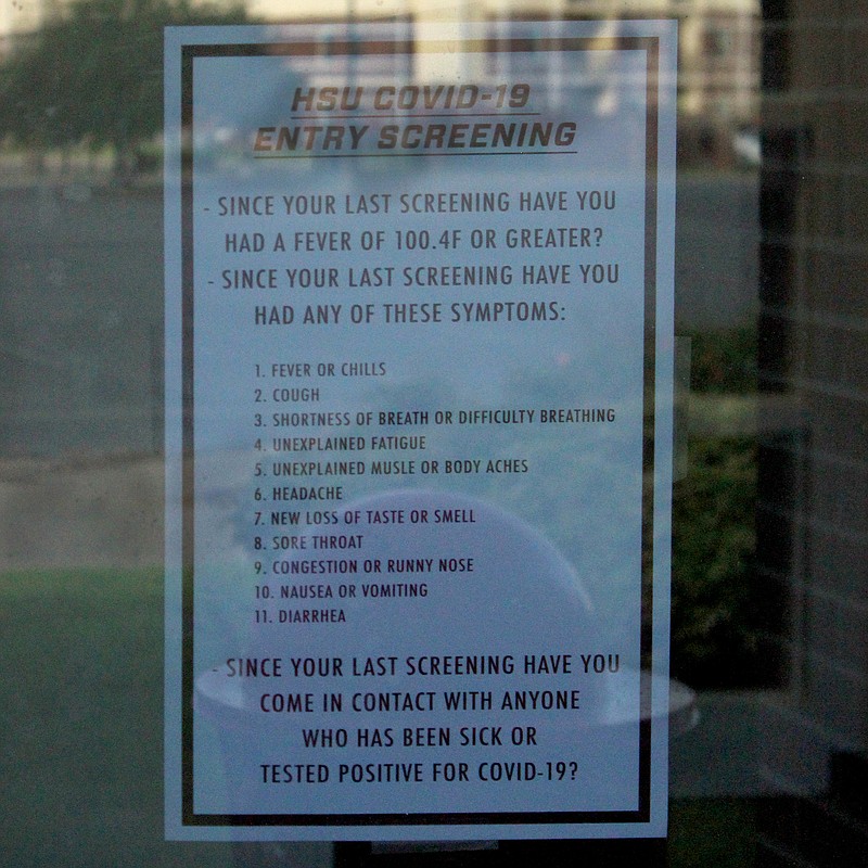A sign with screening questions is posted at an entrance to C.E. Formby Athletic Center at Henderson State University. - Photo by James Leigh of The Sentinel-Record