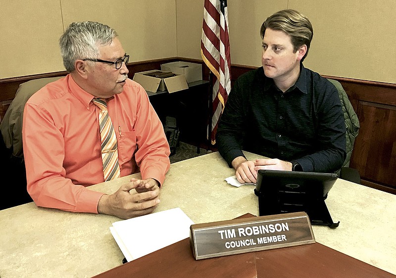 NWA Democrat-Gazette/MIKE JONES
Bentonville City Council members Octavio Sanchez (left) and Tim Robinson speak Tuesday before the start of the Committee of the Whole meeting in Bentonville.
