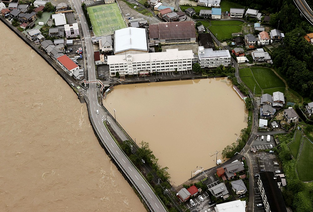 A schoolyard of a junior high school is seen flooded following heavy rains in Gero, Gifu prefecture, central Japan Wednesday, July 8, 2020. Floodwaters flowed down streets in southern Japanese towns hit by heavy rains. (Kyodo News via AP)