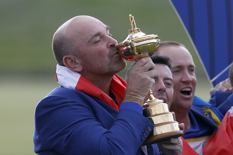 FILE - In this Sept. 30, 2018, file photo, Europe team captain Thomas Bjorn kisses the cup during the trophy presentation after the European team defeated the United States to win the 2018 Ryder Cup golf tournament at Le Golf National in Saint Quentin-en-Yvelines, outside Paris, France. The Ryder Cup was postponed until 2021 in Wisconsin because of the COVID-19 pandemic that raised too much uncertainty whether the loudest event in golf could be played before spectators. The announcement Wednesday, July 8, 2020, was inevitable and had been in the works for weeks as the PGA of America, the European Tour and the PGA Tour tried to adjust with so many moving parts.(AP Photo/Alastair Grant, File)