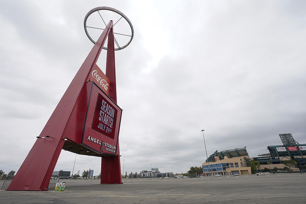 A sign outside Angels Stadium announces Opening Day as July 24, on Wednesday, July 1, 2020, in Anaheim, Calif. The Angels and other Major League Baseball teams will report to their respective facilities for training this week, amid the coronavirus pandemic. (AP Photo/Ashley Landis)