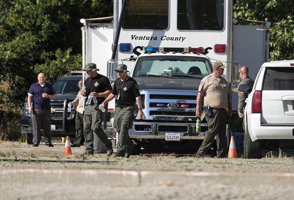 Ventura County Sheriff's deputies appear on the scene in Lake Peru, Calif., Thursday, July 9, 2020, searching for "Glee" star Naya Rivera who was reported missing on Wednesday. Her 4-year-old son was found alone on a rented boat. (AP Photo/Ringo H.W. Chiu)