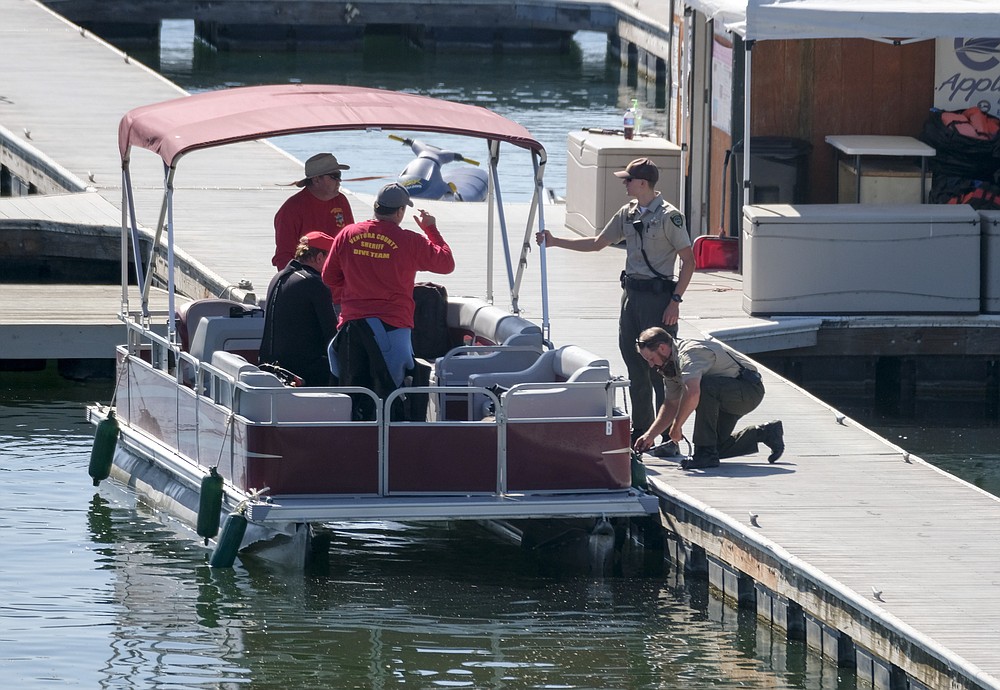 Members of Ventura County Sheriff's Office Underwater Search and Rescue Team help in the search for former "Glee" star Naya Rivera, Thursday, July 9, 2020 in Lake Peru, Calif. (AP Photo/Ringo H.W. Chiu)