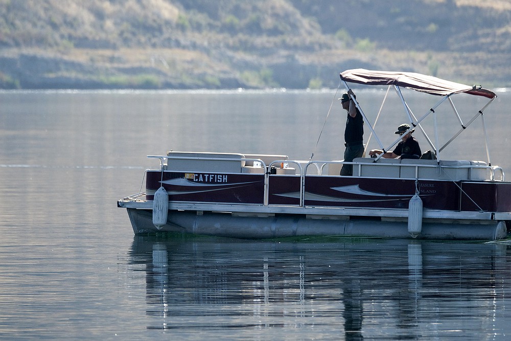 Members of Ventura County Sheriff's Office Underwater Search and Rescue Team search for former "Glee" actress Naya Rivera, Thursday, July 9, 2020 in Lake Peru, Calif. Rivera rented a boat on Wednesday and her 4-year-old son was found alone on the rented boat. (AP Photo/Ringo H.W. Chiu)