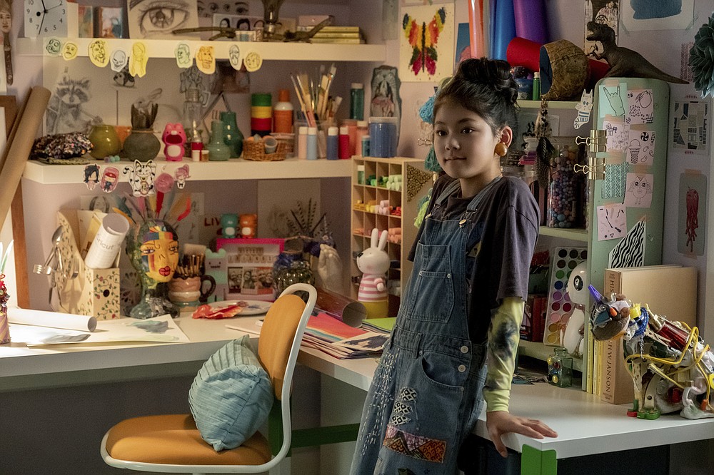 This image released by Netflix shows Momona Tamada portraying Claudia Kishi in a scene from the Netflix series "The Baby-Sitters Club," based on the popular book series. With 180 million copies in print worldwide, "The Baby-Sitters Club” books were a juggernaut during their 1986-2000 run. They follow Claudia, Kristy, Mary Anne, Stacey and Dawn and their babysitting adventures in the fictional suburb of Stoneybrook, Connecticut. (Kailey Schwerman/Netflix via AP)