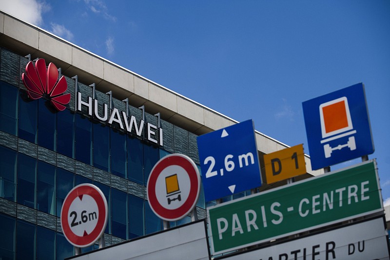 A logo sits on the exterior of Huawei Technologies offices in Paris on July 7, 2020. (Bloomberg photo by Nathan Laine)