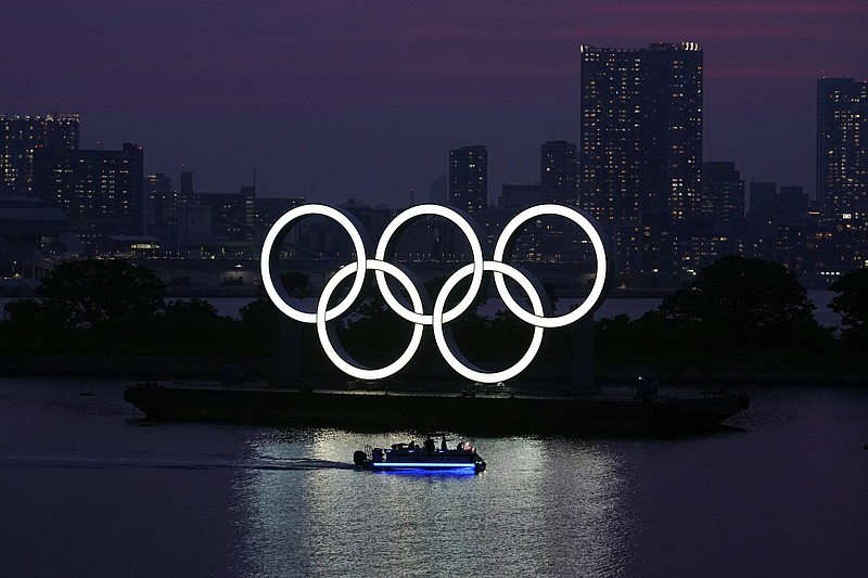 The Olympic rings float in the water at sunset in the Odaiba section on June 3 in Tokyo. Masa Takaya, the spokesman for the Tokyo Olympics, said Thursday, July 9, 2020, he’s confident the postponed games can be held in 2021 despite a recent poll in Japan in which 77% of respondents said they did not believe the games could be held next year. - Photo by Eugene Hoshiko of The Associated Press