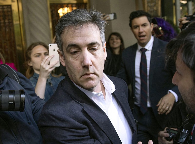 In this May 6, 2019, file photo, Michael Cohen, former attorney to President Donald Trump, leaves his apartment building before beginning his prison term in New York. Cohen, was returned to federal prison, weeks after his early release to serve the remainder of his sentence at home because of the coronavirus pandemic, the federal Bureau of Prisons said Thursday. - AP Photo/Kevin Hagen