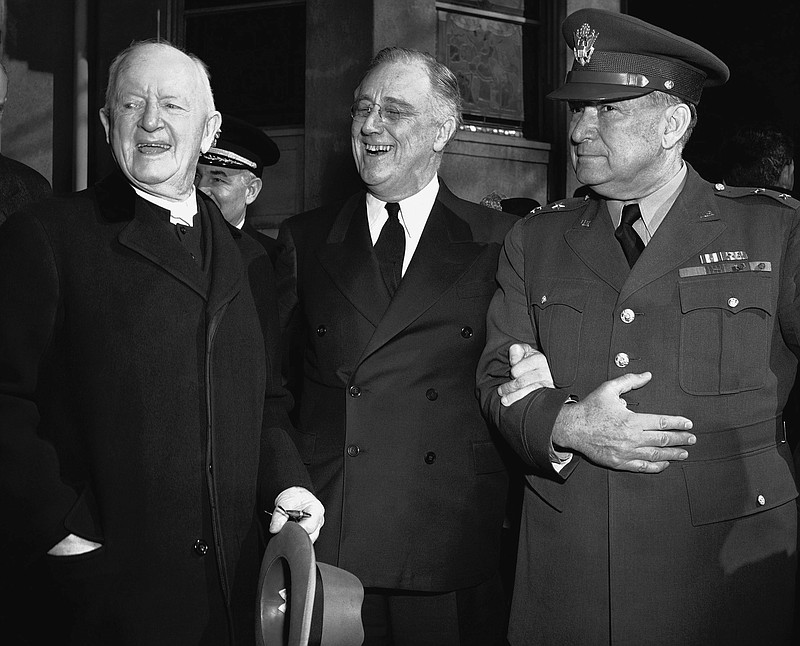 In this March 4, 1942 file photo, President Franklin Roosevelt leaves after prayer services at St. John's Episcopal Church in Washington, following his custom of attending church on each anniversary of his first inauguration on March 4, 1933. As he left the church he stopped to talk with the Rev. Endicott Peabody, left, headmaster emeritus of Groton school. At right is Major General Edwin M. Watson, presidential secretary and military aide. - AP Photo