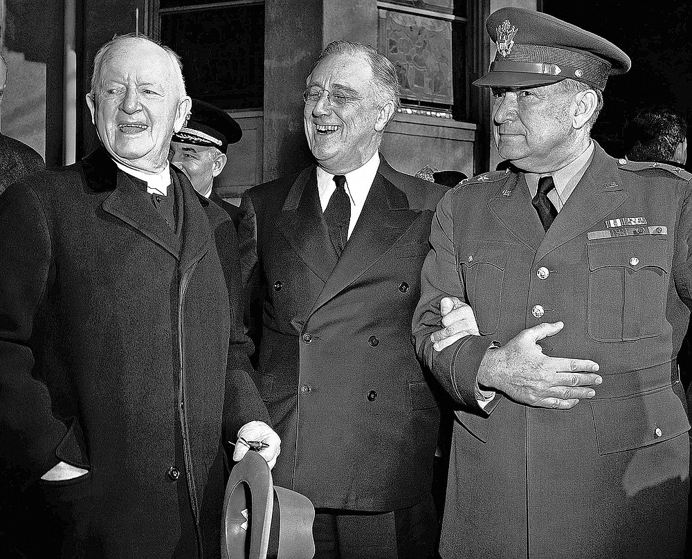 FILE - In this March 4, 1942 file photo, President Franklin Roosevelt leaves after prayer services at St. John's Episcopal Church in Washington, following his custom of attending church on each anniversary of his first inauguration on March 4, 1933. As he left the church he stopped to talk with the Rev. Endicott Peabody, left, headmaster emeritus of Groton school. At right is Major General Edwin M. Watson, presidential secretary and military aide. (AP Photo)