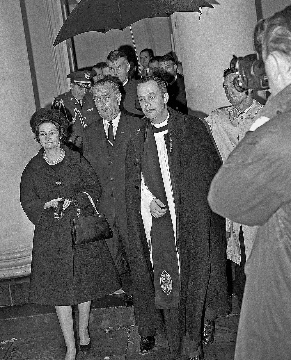FILE - In this Nov. 23, 1963 file photo, President Lyndon Johnson and his wife, Lady Bird, leave St. John's Episcopal Church in Washington after attending special services. With them is the rector, the Rev. John C. Harper. Johnson was sworn in as president shortly after the assasisnation of John F. Kennedy in Dallas on Nov. 22. (AP Photo)