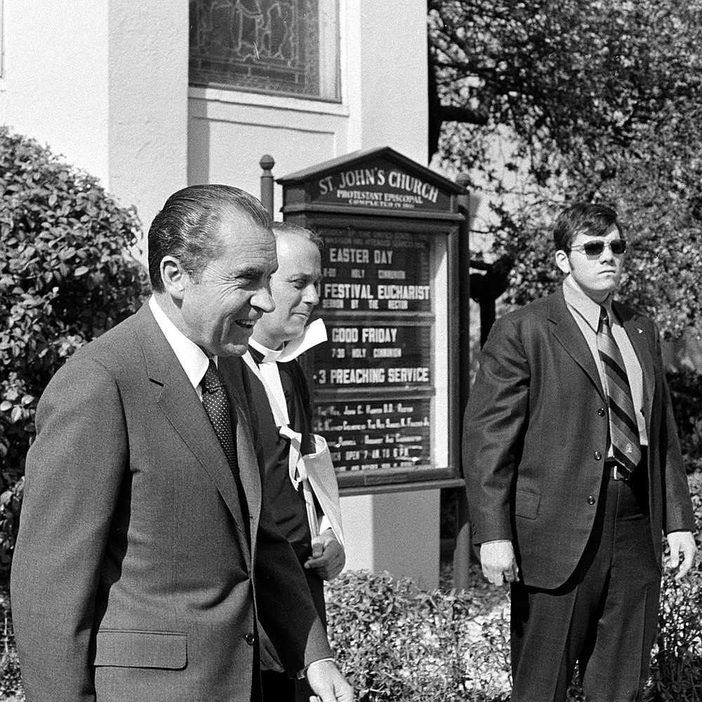 FILE - In this April 1971 file photo, President Richard Nixon, left foreground, walks with Rev. John C. Harper, after attending a Good Friday services at St. John's Episocpal Church near the White House. Every president since James Madison has crossed Lafayette Square to worship at St. John's, the pale yellow Episcopal church within sight of the White House. (AP Photo/Charles Tasnadi)