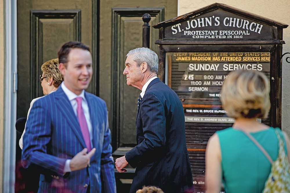 FILE - In this Sunday, April 21, 2019 file photo, special counsel Robert Mueller, center, and his wife Ann Cabell Standish, left, arrive for Easter services at St. John's Episcopal Church in Washington. St. John's was in the spotlight in 2019 when Mueller, a church regular, was photographed there shortly after submitting his final report on Russian involvement in the 2016 election. Trump had visited the church the preceding week. (AP Photo/Andrew Harnik)