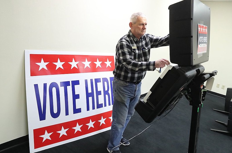 Garland County Election Commission Chairman Gene Haley sets up one of the county's voting machines at Hot Springs Mall in February 2020. - Photo by Richard Rasmussen of The Sentinel-Record